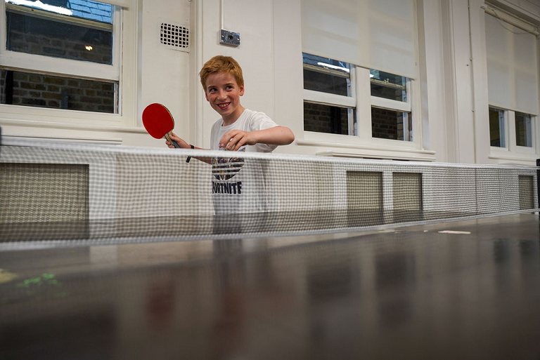 A picture of a boy playing table tennis